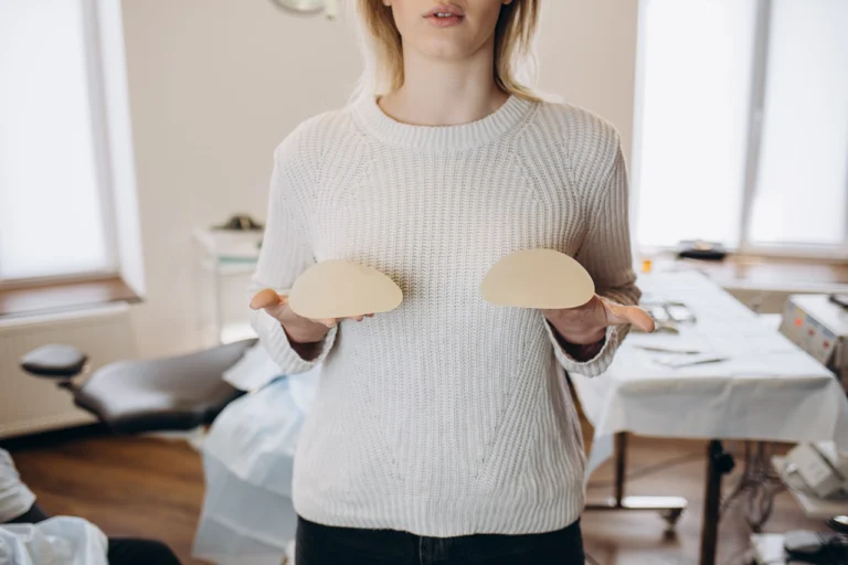 woman in white with implants in hand