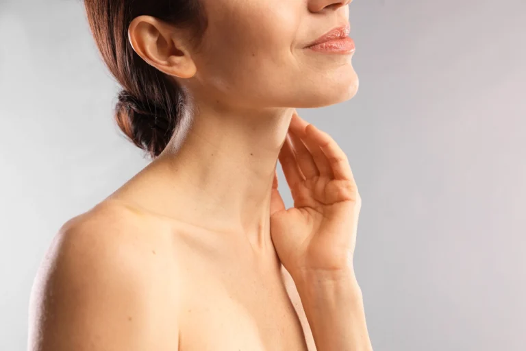 woman gently touching her neck