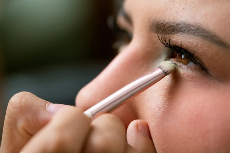 close up of woman applying eye makeup