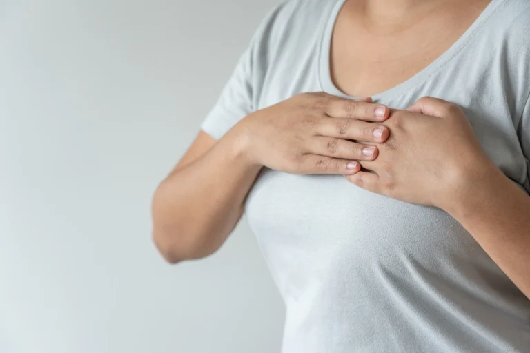 woman pressing her hands are on top of her breasts
